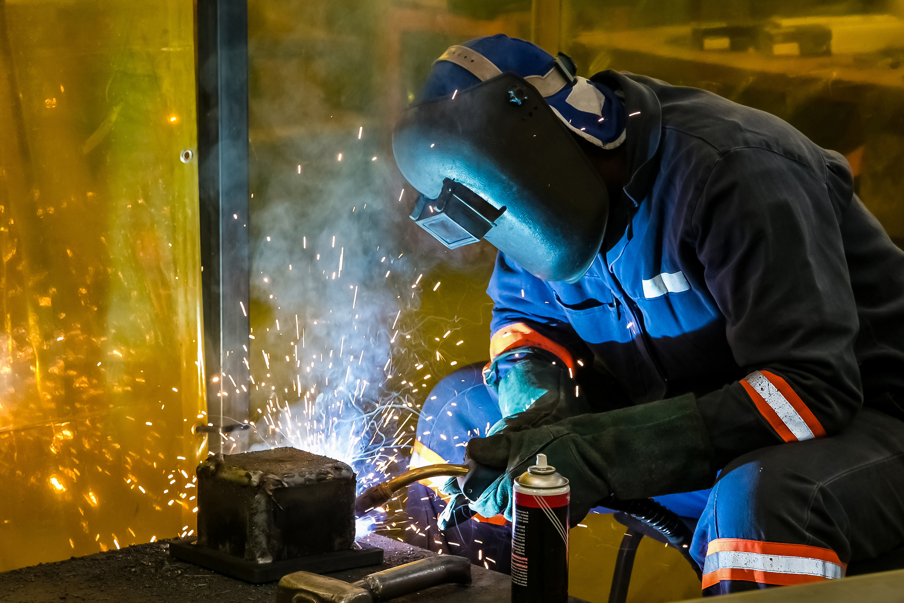 A male working with a welding torch